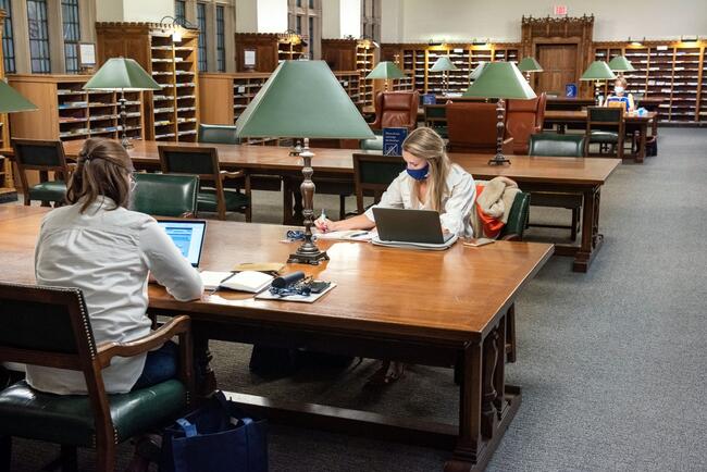 Two girls studying in the Periodical Reading room