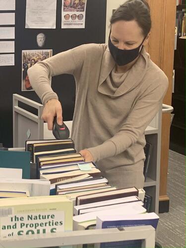 University Librarian Barbara Rockenbach scans books