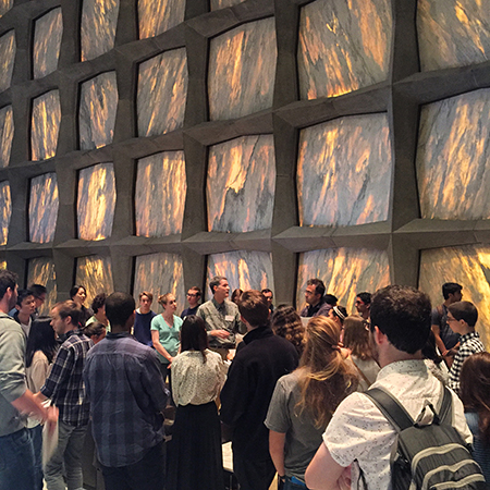 Crowd of students with Beinecke Library director inside the library