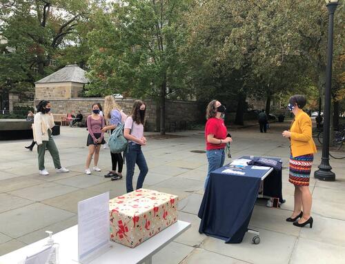 Students wait in line to write postcards for the University archives