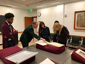 Curator George Miles displays photobooks from the Beinecke Library collection.
