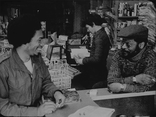 A convenience store employee and customer talking while shooting  Black at Yale