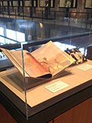 Exhibit case with three items related to Mandela from Yale library collections, a book, a photo and a poster.