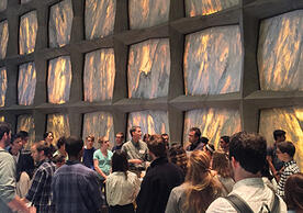 Crowd of students with Beinecke Library director inside the library