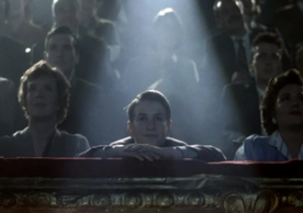 Still from the film showing an audience sitting in a movie theater.
