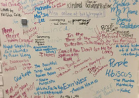 whiteboard surface covered with handwritten book titles