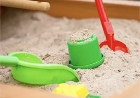 plastic spades and containers in a sandbox