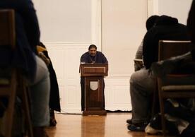 Minister at pulpit with people in pews