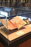 Exhibit case with three items related to Mandela from Yale library collections, a book, a photo and a poster.